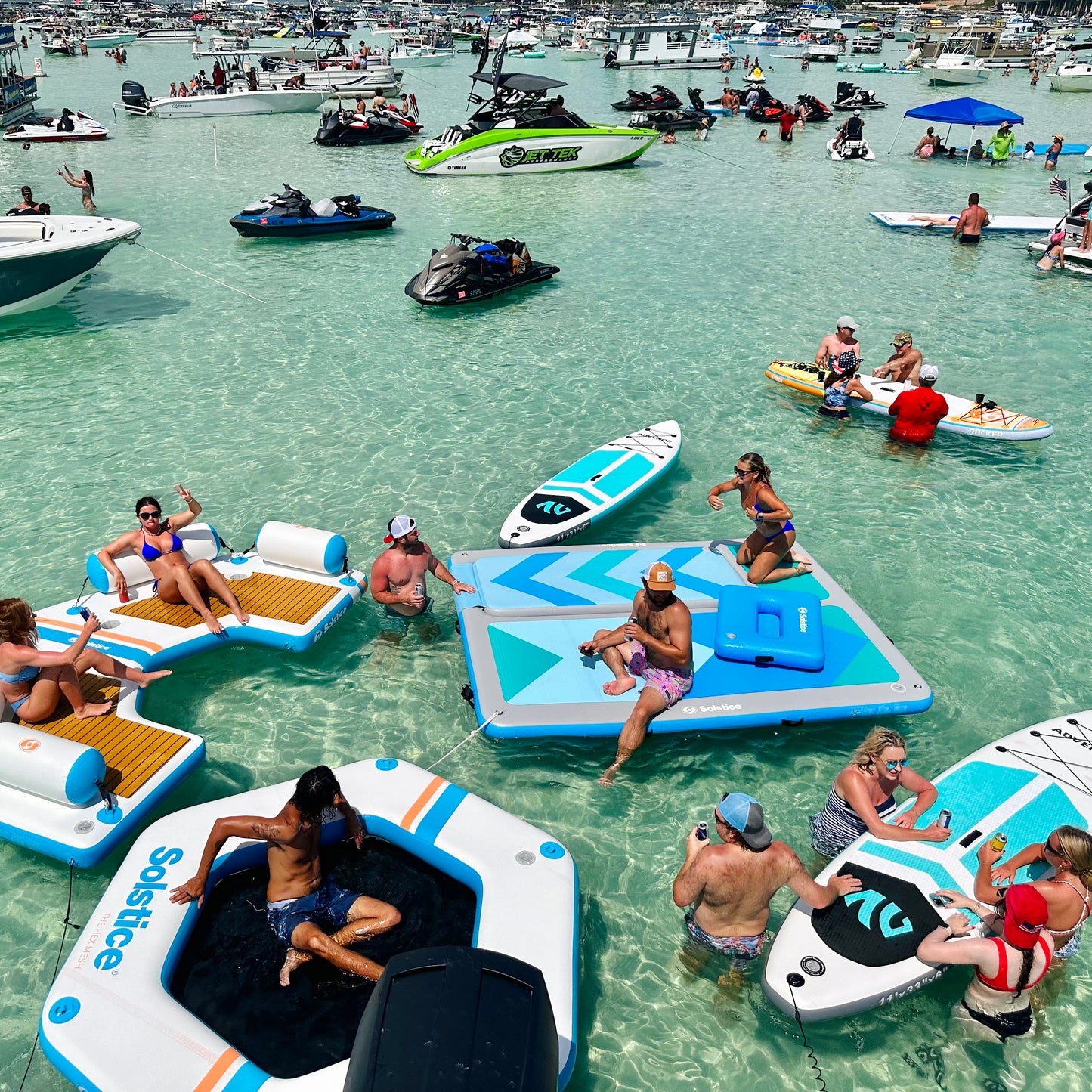 Family enjoying inflatable water floats and couch at Crab Island Destin Florida