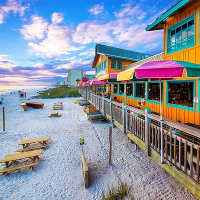 View of the beachfront Back Porch restaurant at Sunset