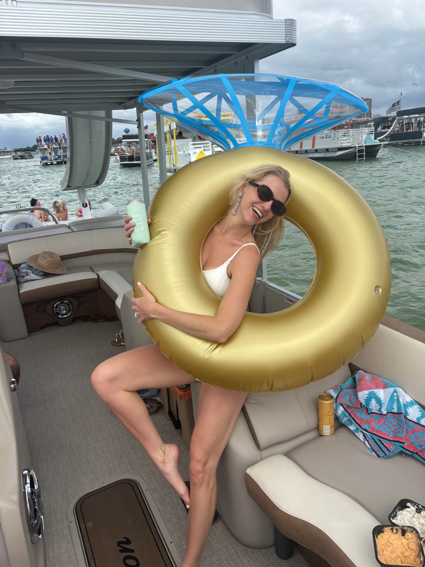 Bachelorette holding ring floatie on slide boat rental at Crab Island