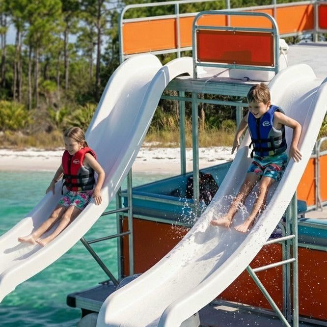Two children sliding down boat water slide in Destin Florida