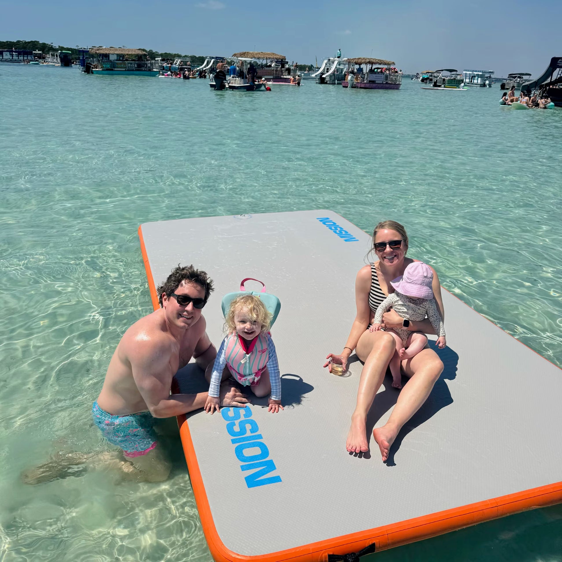 Young family on inflatable water mat at Crab Island
